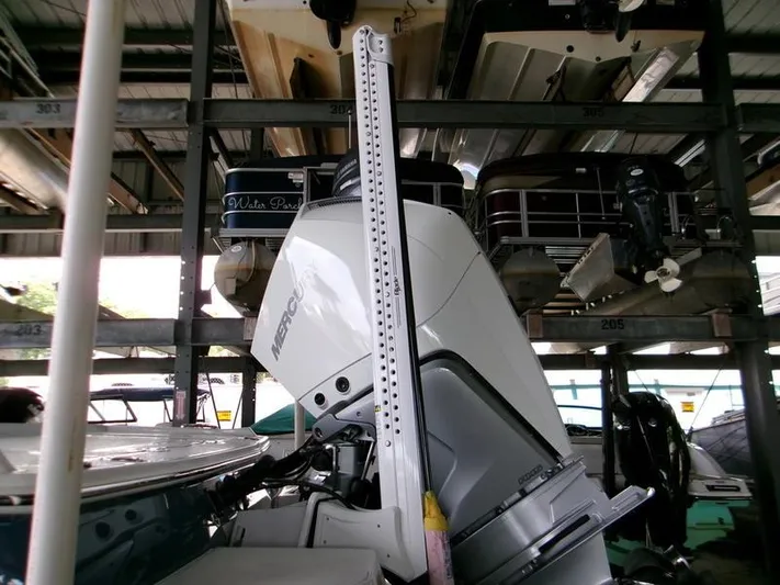  Yacht Photos Pics 2026 Blackfin 242 HB boat with Mercury outboard motor in storage facility.