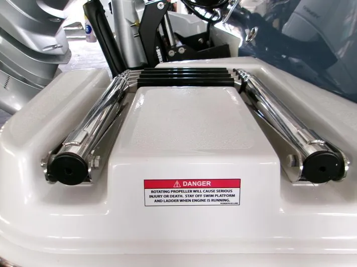  Yacht Photos Pics 2026 Blackfin 242 HB swim platform with safety warning label and ladder.