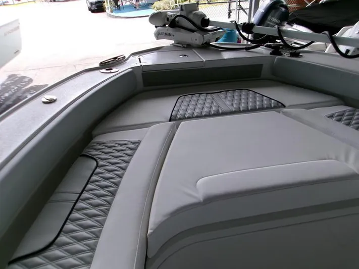  Yacht Photos Pics Interior view of 2026 Blackfin 242 HB boat with cushioned seating and Garmin equipment.