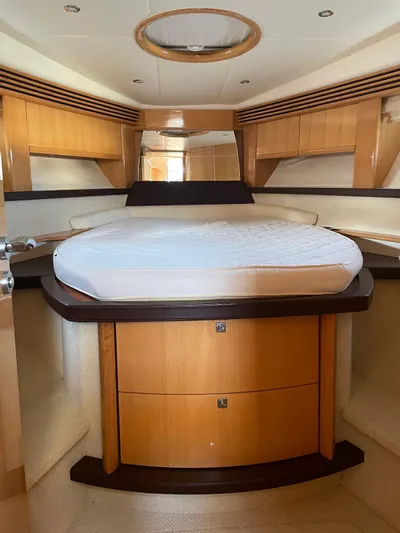 Yacht Photos Pics Luxurious interior of a 2008 Absolute 47 HT yacht with a cozy bed and wooden cabinetry.