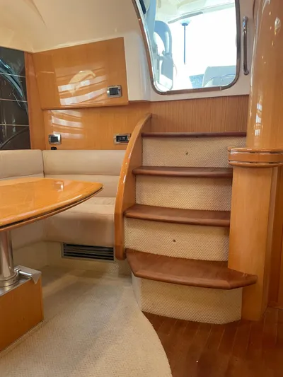  Yacht Photos Pics Interior of 2008 Absolute 47 HT yacht with wooden stairs and seating area.