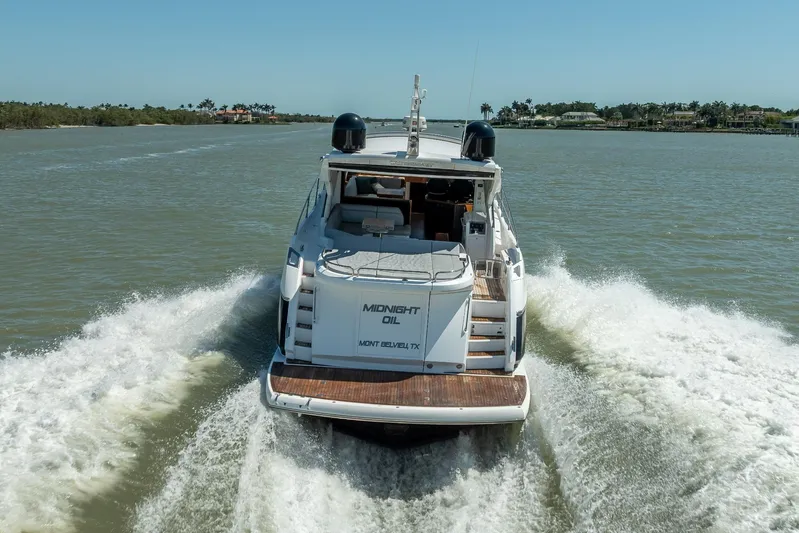 Midnight Oil Yacht Photos Pics 2018 Sunseeker Predator 57 yacht cruising on open water, rear view.