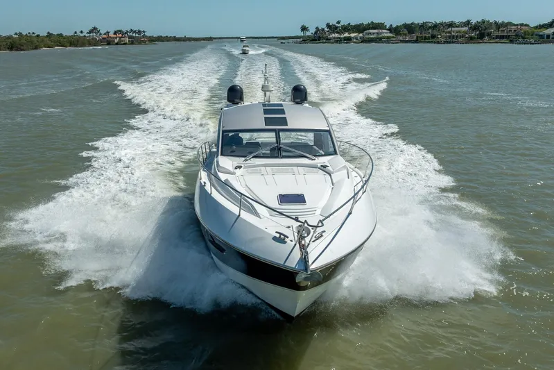 Midnight Oil Yacht Photos Pics 2018 Sunseeker Predator 57 yacht cruising on a sunny day, leaving a wake behind.