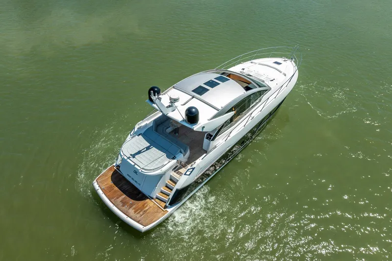 Midnight Oil Yacht Photos Pics 2018 Sunseeker Predator 57 yacht cruising on calm green waters.