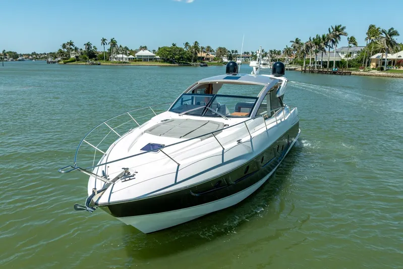 Midnight Oil Yacht Photos Pics 2018 Sunseeker Predator 57 yacht cruising on a sunny day in a scenic waterway.