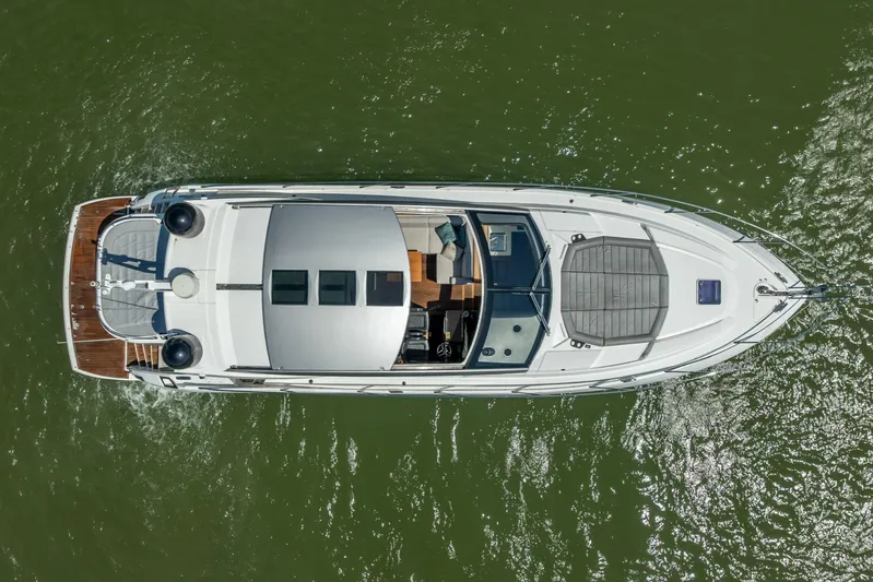 Midnight Oil Yacht Photos Pics Overhead view of 2018 Sunseeker Predator 57 yacht cruising on green water.