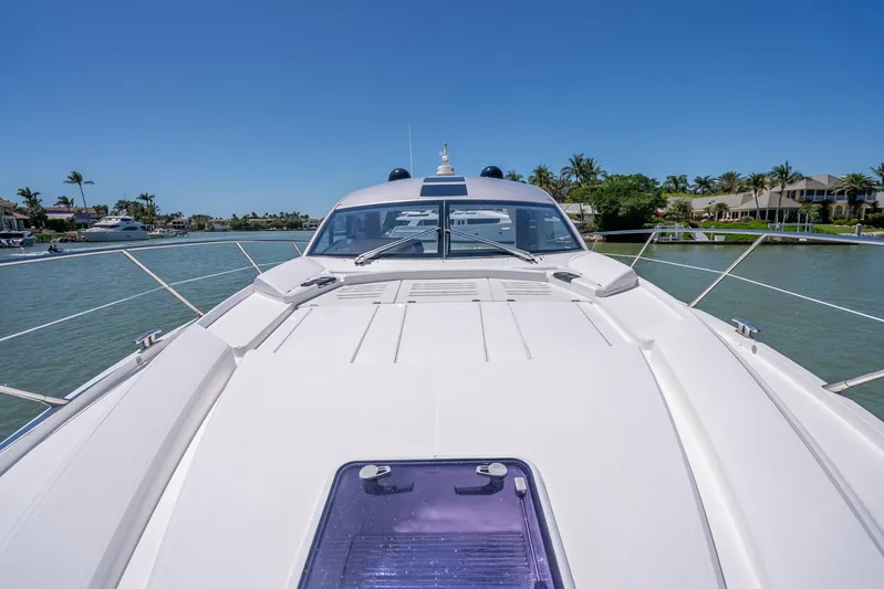 Midnight Oil Yacht Photos Pics 2018 Sunseeker Predator 57 yacht on calm waters, showcasing sleek design and luxury features.