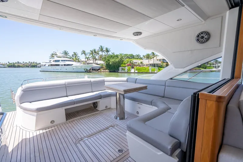 Midnight Oil Yacht Photos Pics Luxurious 2018 Sunseeker Predator 57 yacht interior with elegant seating and scenic waterfront view.