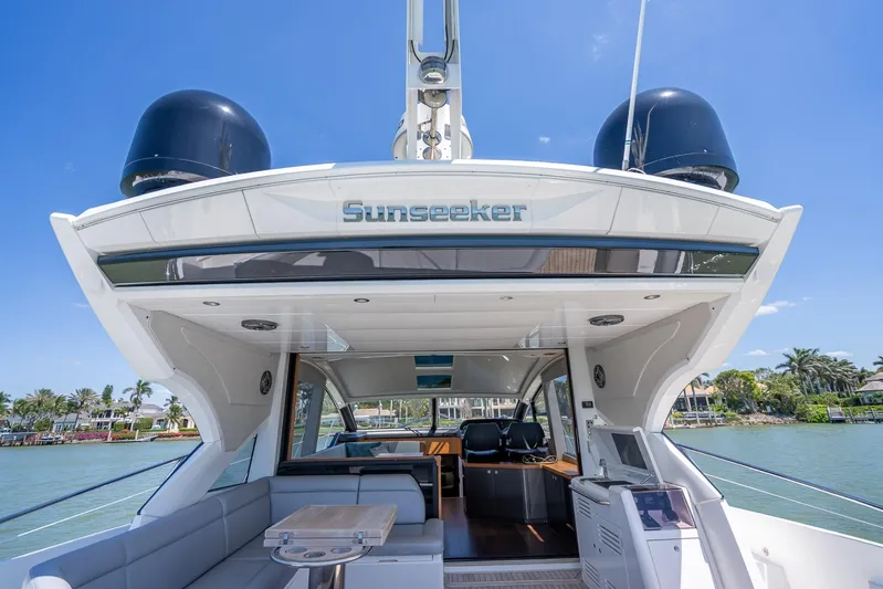 Midnight Oil Yacht Photos Pics 2018 Sunseeker Predator 57 yacht, luxurious deck view, sunny waterfront setting.