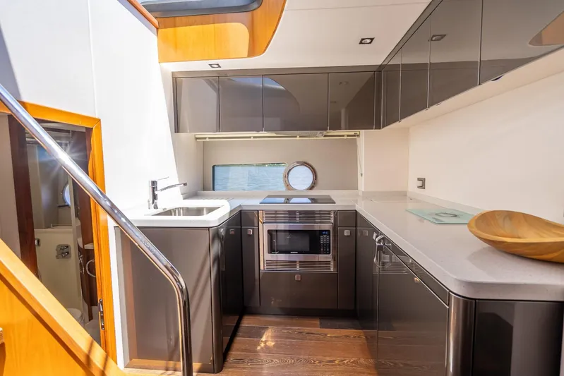 Midnight Oil Yacht Photos Pics Luxurious kitchen interior of 2018 Sunseeker Predator 57 yacht with modern appliances.