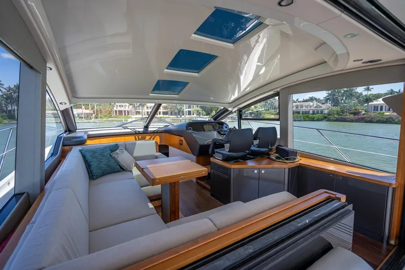 Midnight Oil Yacht Photos Pics Luxurious interior of 2018 Sunseeker Predator 57 yacht with spacious seating and modern helm.