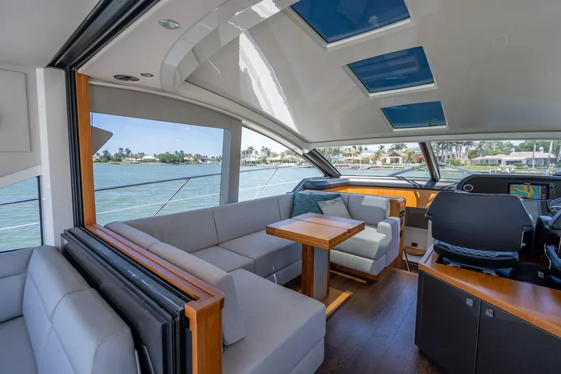 Midnight Oil Yacht Photos Pics Luxurious interior of 2018 Sunseeker Predator 57 yacht with modern seating and panoramic views.