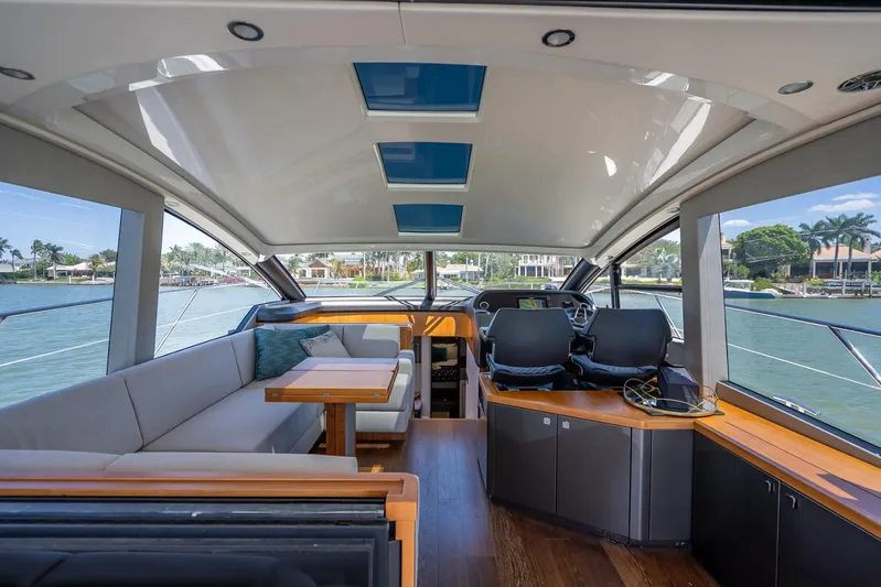 Midnight Oil Yacht Photos Pics Luxurious interior of 2018 Sunseeker Predator 57 yacht with panoramic windows and modern seating.