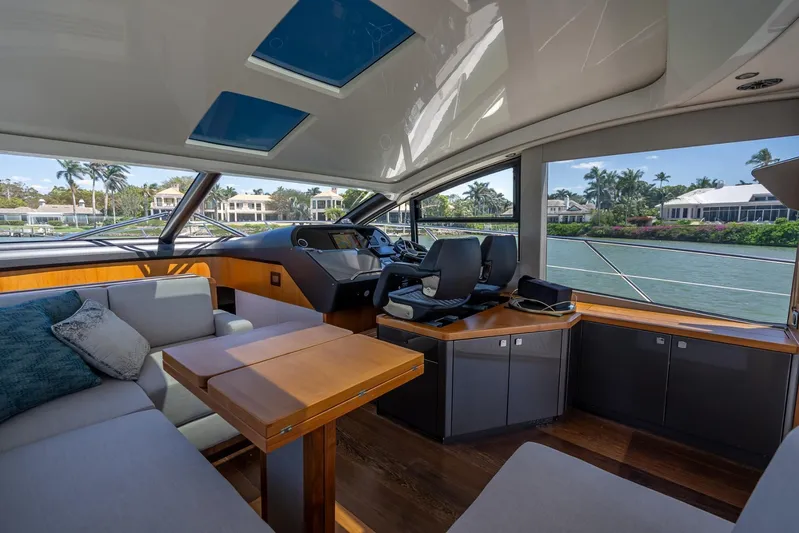 Midnight Oil Yacht Photos Pics Luxurious interior of 2018 Sunseeker Predator 57 yacht with modern helm and seating area.