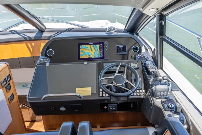 Midnight Oil Yacht Photos Pics Cockpit of 2018 Sunseeker Predator 57 yacht with navigation equipment and steering wheel.