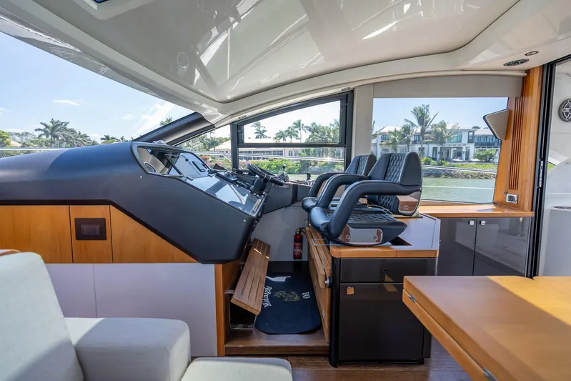 Midnight Oil Yacht Photos Pics Interior of 2018 Sunseeker Predator 57 yacht, featuring modern helm and luxurious seating.