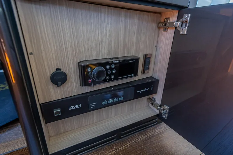 Midnight Oil Yacht Photos Pics Control panel inside a 2018 Sunseeker Predator 57 yacht, featuring Fusion and TracVision systems.