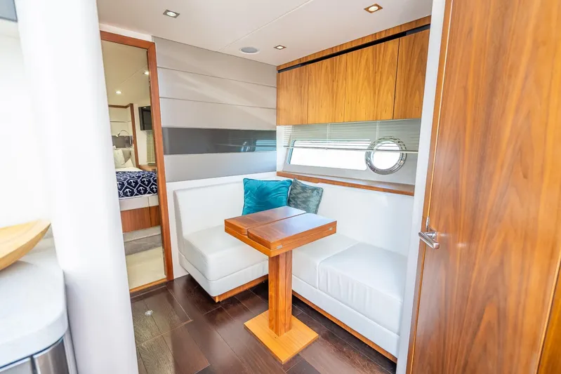 Midnight Oil Yacht Photos Pics Luxurious interior of 2018 Sunseeker Predator 57 yacht with elegant seating and wooden accents.