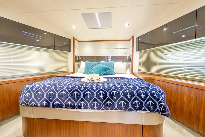 Midnight Oil Yacht Photos Pics Luxurious bedroom interior of 2018 Sunseeker Predator 57 yacht with nautical-themed decor.