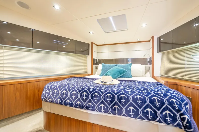 Midnight Oil Yacht Photos Pics Luxurious bedroom interior of 2018 Sunseeker Predator 57 yacht with nautical-themed decor.