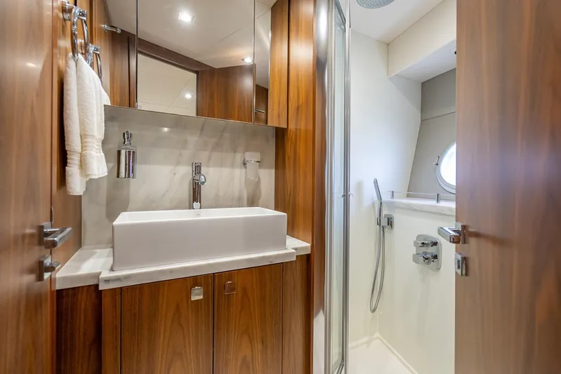 Midnight Oil Yacht Photos Pics Luxurious bathroom in 2018 Sunseeker Predator 57 yacht with modern fixtures and wood accents.