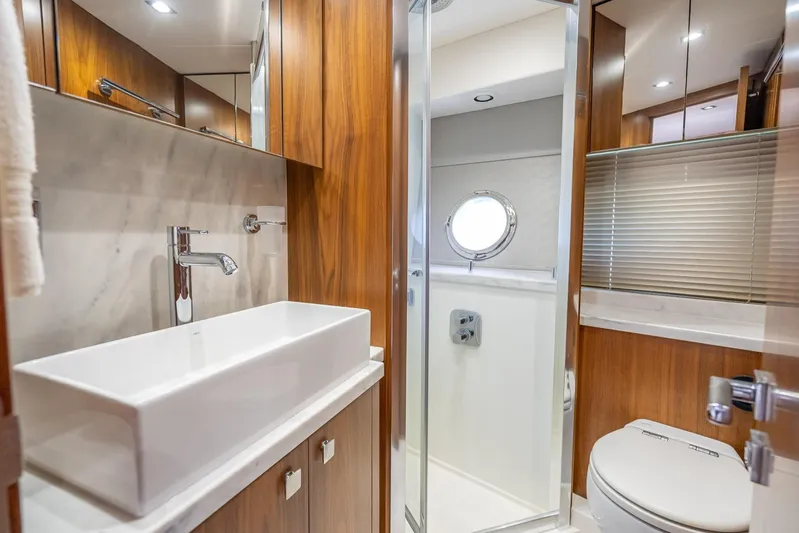 Midnight Oil Yacht Photos Pics Luxurious bathroom interior of 2018 Sunseeker Predator 57 yacht with modern fixtures.