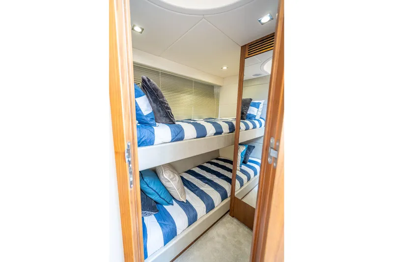 Midnight Oil Yacht Photos Pics Bunk beds in 2018 Sunseeker Predator 57 yacht cabin with striped bedding.