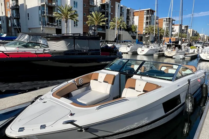  Yacht Photos Pics 2019 Four Winns Horizon H290 boat docked in a marina with modern buildings.