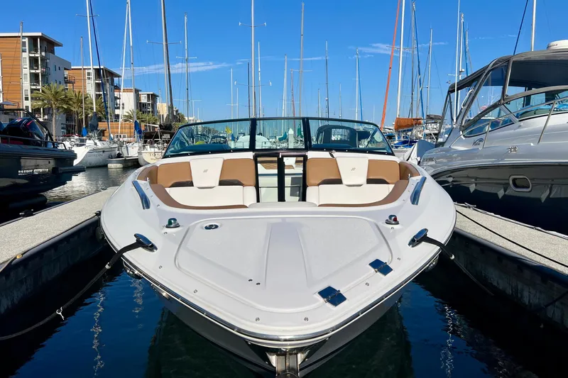  Yacht Photos Pics 2019 Four Winns Horizon H290 boat docked in a marina, surrounded by other vessels.