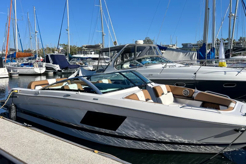  Yacht Photos Pics 2019 Four Winns Horizon H290 boat docked in a marina, surrounded by other vessels.