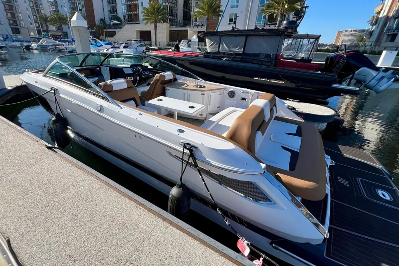  Yacht Photos Pics 2019 Four Winns Horizon H290 boat docked in a marina, featuring sleek design and spacious seating.