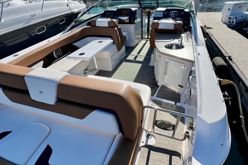 Yacht Photos Pics 2019 Four Winns Horizon H290 boat interior with seating, table, and kitchenette.