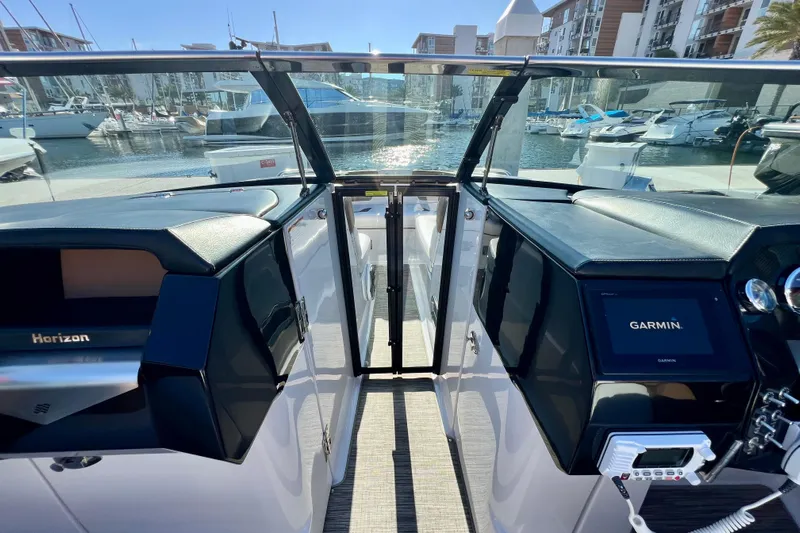  Yacht Photos Pics 2019 Four Winns Horizon H290 boat cockpit with Garmin navigation system, docked in marina.