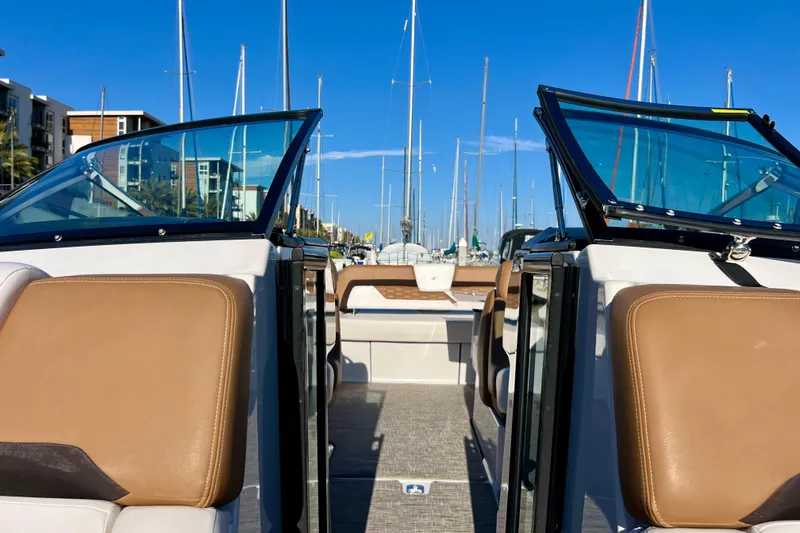  Yacht Photos Pics 2019 Four Winns Horizon H290 boat interior with tan seats and marina view.