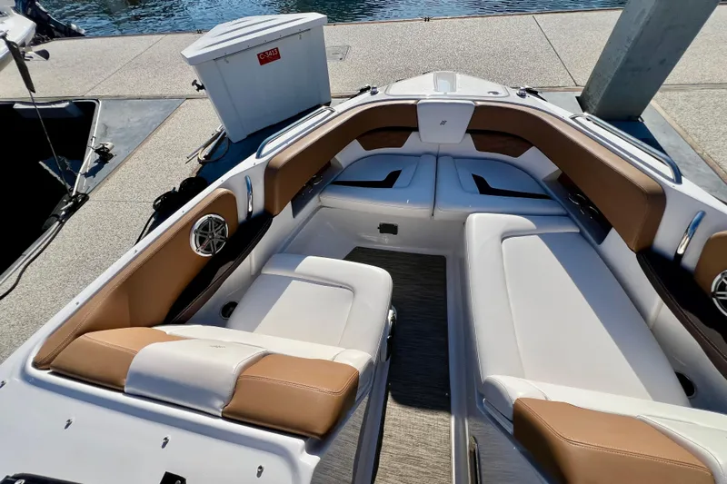  Yacht Photos Pics 2019 Four Winns Horizon H290 boat interior with tan and white seating at dock.