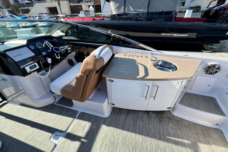  Yacht Photos Pics 2019 Four Winns Horizon H290 boat interior with helm, seating, and kitchenette.