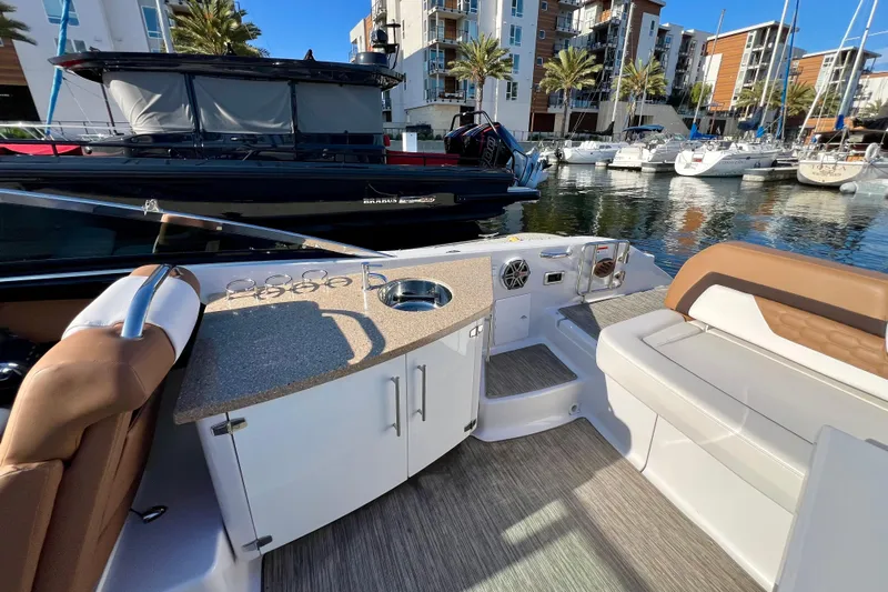  Yacht Photos Pics 2019 Four Winns Horizon H290 boat interior with seating and kitchenette, docked at marina.