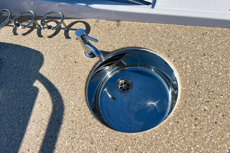  Yacht Photos Pics 2019 Four Winns Horizon H290 boat sink with chrome faucet on textured surface.