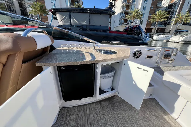 Yacht Photos Pics 2019 Four Winns Horizon H290 boat interior with kitchenette and seating area.