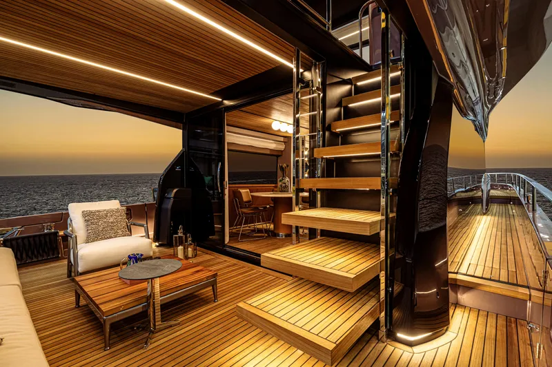  Yacht Photos Pics Luxurious 2025 Cranchi Sessantadue 62 yacht interior with elegant wooden deck at sunset.