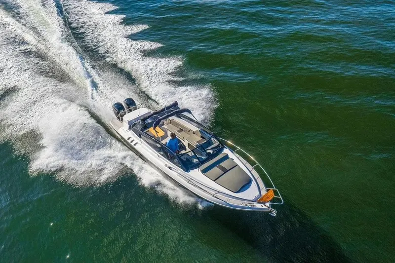  Yacht Photos Pics Aerial view of 2025 Hanover 305 boat cruising on open water.
