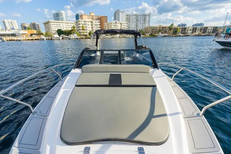  Yacht Photos Pics 2025 Hanover 305 boat on water with city skyline in background.