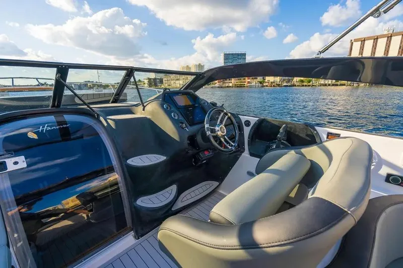  Yacht Photos Pics Luxurious Hanover 305 boat interior, 2025 model, featuring sleek design and modern controls on a sunny day.