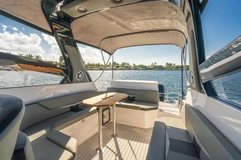  Yacht Photos Pics Luxurious Hanover 305 yacht interior, 2025 model, with elegant seating and scenic water view.
