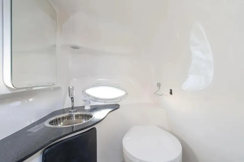  Yacht Photos Pics Modern bathroom in Hanover 305, 2025 model, featuring sleek sink and compact toilet design.