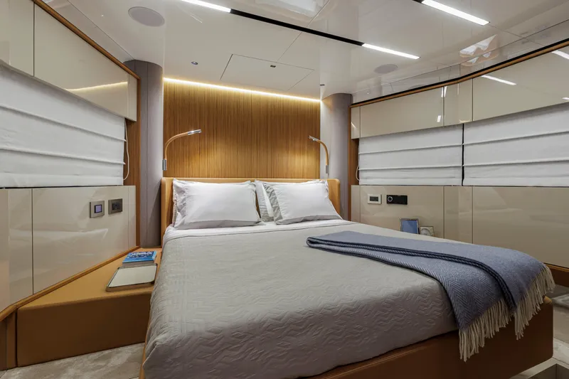  Yacht Photos Pics Luxurious bedroom interior of 2026 Cranchi Sessantadue 62 yacht with modern design elements.