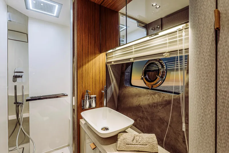  Yacht Photos Pics Luxurious bathroom interior of 2026 Cranchi Sessantadue 62 yacht with modern fixtures.