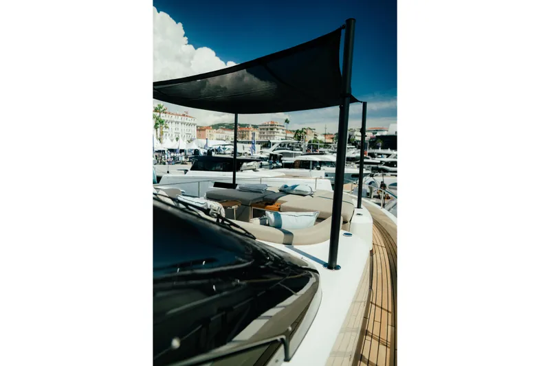  Yacht Photos Pics 2026 Cranchi Sessantadue 62 yacht deck with sunshade, docked in a marina.