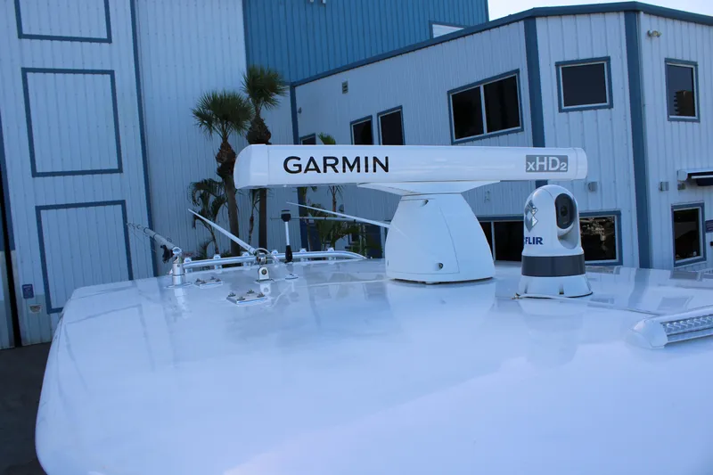  Yacht Photos Pics Radar and camera equipment on a 1998 Venture 34 Open boat, near a blue building.