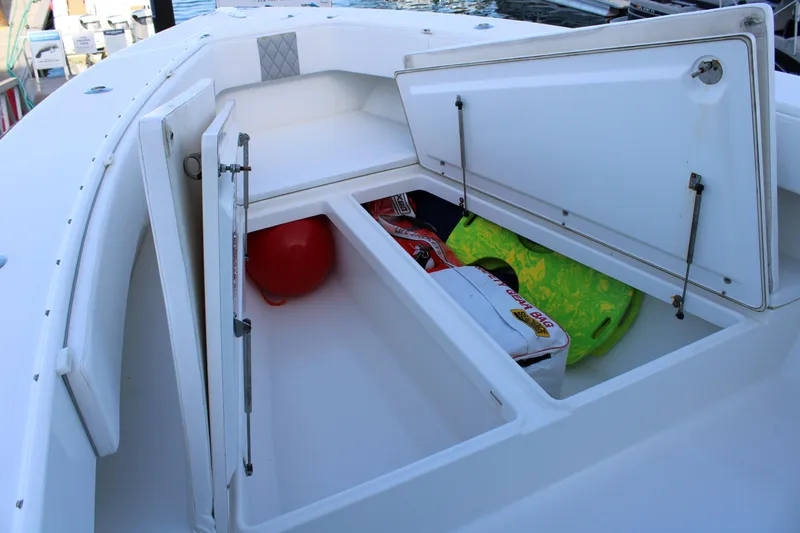  Yacht Photos Pics Open storage compartments on a 1998 Venture 34 Open boat, containing various boating gear.